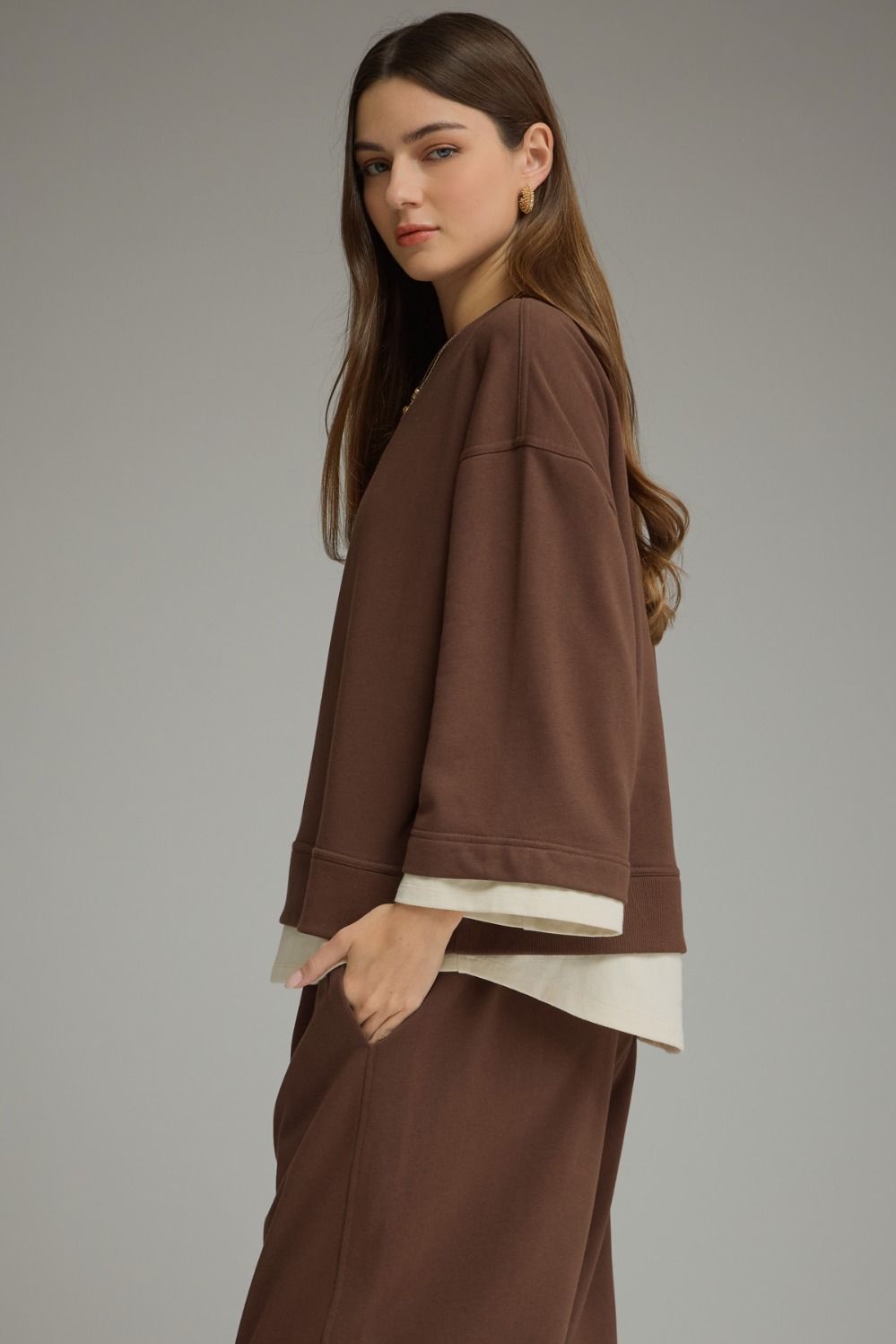 Brown long sleeve top with a round neckline