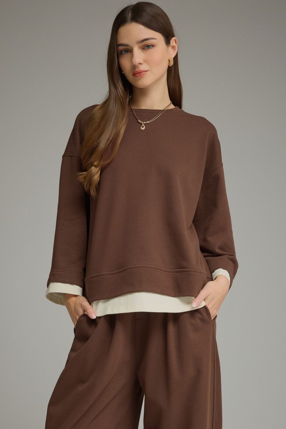 Brown long sleeve top with a round neckline
